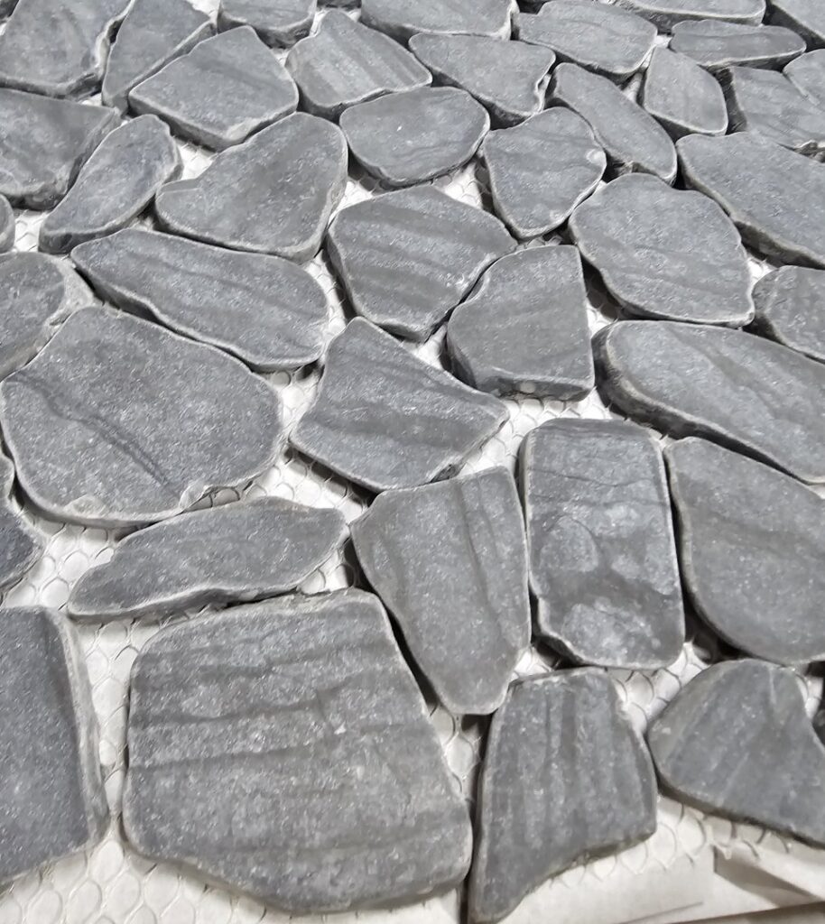 Various flooring product displays, including wood and tile samples, inside the Bronco Carpets and Flooring showroom in Caldwell, ID.