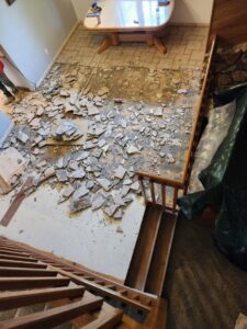 An overhead view of a room with old flooring debris, indicating removal work by Front Range Interiors in Greeley, CO.
