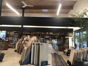 Various flooring samples and rugs displayed in the showroom of Artifacts Fine Rugs and Flooring in South Salt Lake, UT.