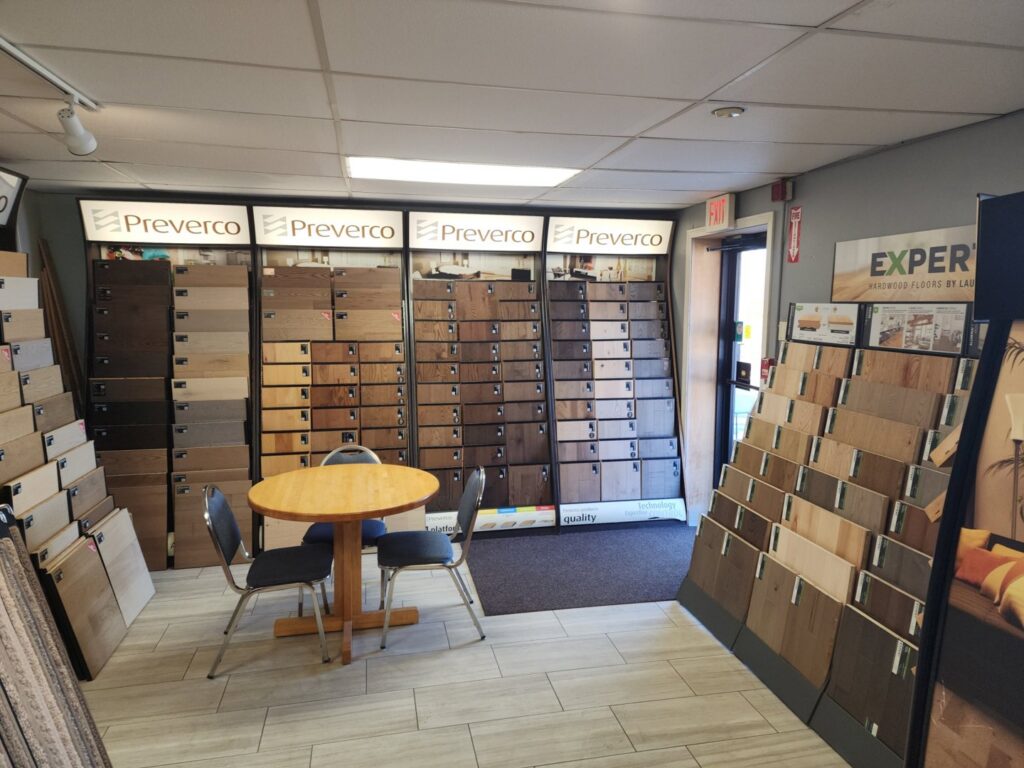 A wide shot of the flooring showroom with multiple sample displays at CarpetsPlus Colortile in Swansea, MA