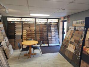 A wide shot of the flooring showroom with multiple sample displays at CarpetsPlus Colortile in Swansea, MA
