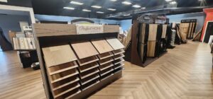 A spacious flooring showroom featuring a herringbone pattern floor at CarpetsPlus Colortile in Swansea, MA