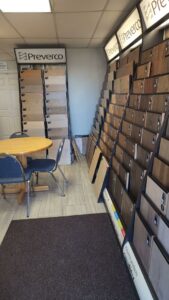 An interior view of the flooring showroom with various wood and laminate samples at CarpetsPlus Colortile in Swansea, MA