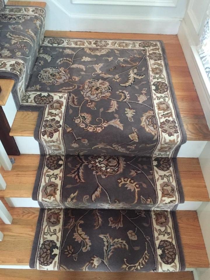 A floral patterned carpet runner installed on a staircase by Harry's Carpet One in Quincy, MA.