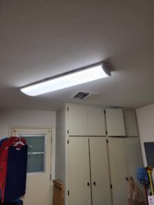 A newly installed fluorescent light fixture on a ceiling by Efficient Electric in Canton, MI.