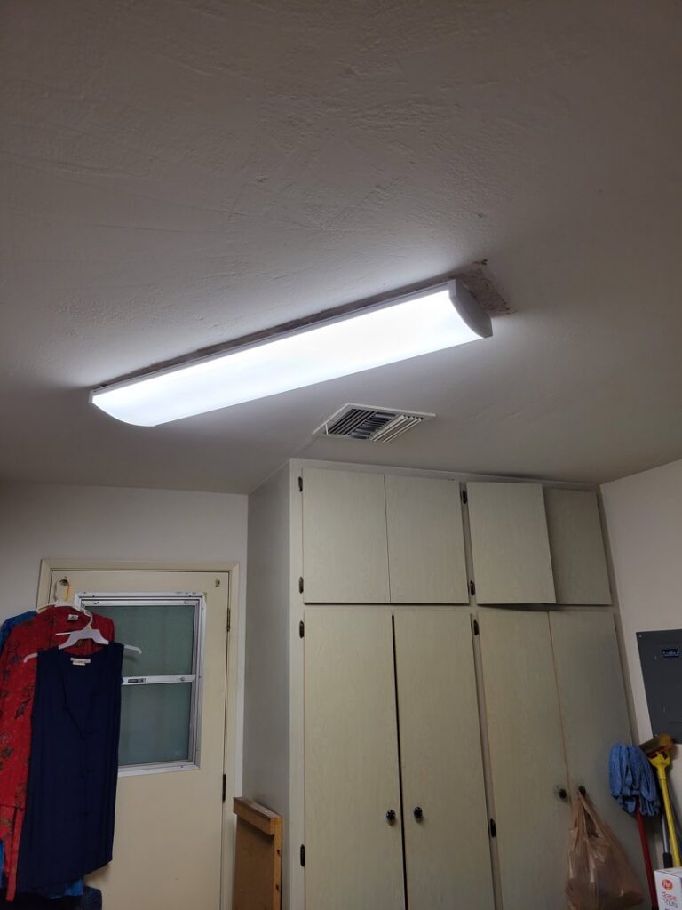 A newly installed fluorescent light fixture on a ceiling by Efficient Electric in Canton, MI.