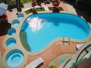 An aerial view of a unique foot-shaped swimming pool, sparkling clean, serviced by Big Foot Pool Care in Buckeye, AZ