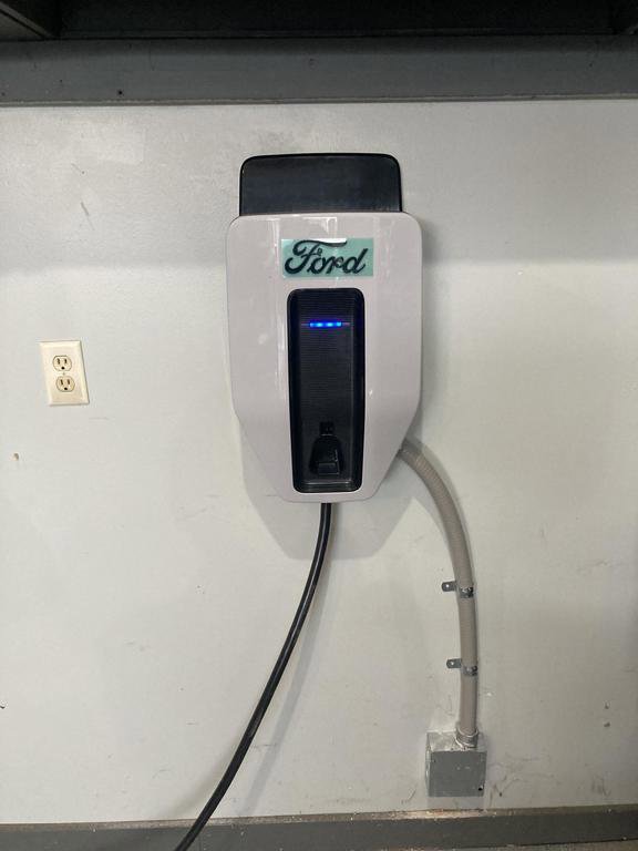 A Ford EV charging station installed on a garage wall by Detroit Voltage in Detroit, MI.