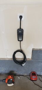 A Ford electric vehicle (EV) charger installed on a garage wall by Midway Electric Inc. in Columbia, MO.