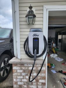 A Ford electric vehicle charger installed on a garage wall by Washington Generators LLC in Kent, WA.