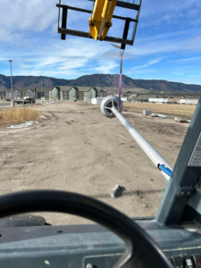 A forklift installing a new street light pole for GDS Electric Inc. in Colorado Springs, CO