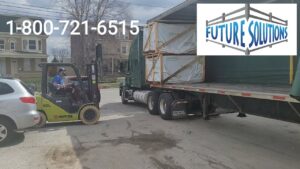 A forklift loading fence materials onto a flatbed truck for Future Solutions Fence Supply in York, PA