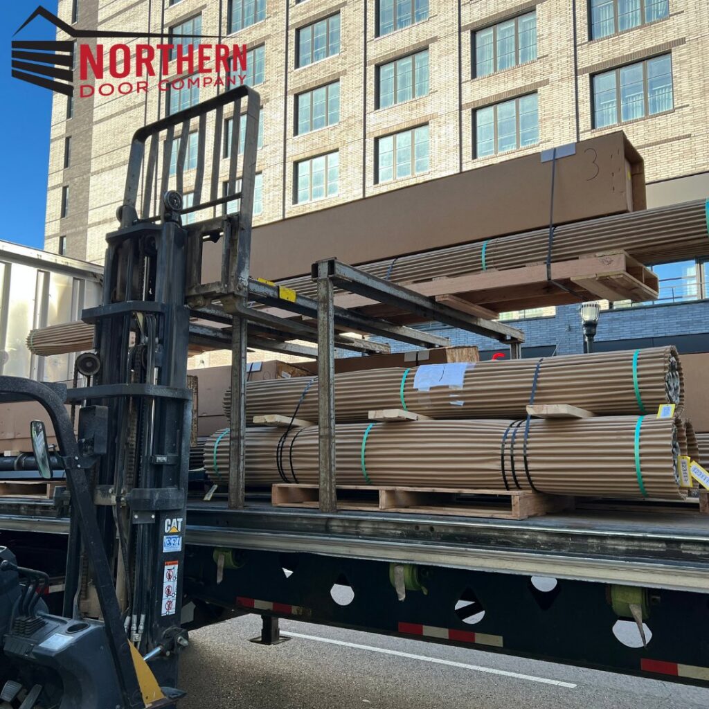 A forklift loading garage door components and materials onto a truck for Northern Door Company in Murfreesboro, TN