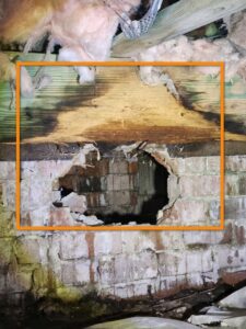 Significant foundation damage with a large hole, likely caused by wildlife or termites, addressed by Hug-A-Bug Pest Control & Termite in Virginia Beach, VA.