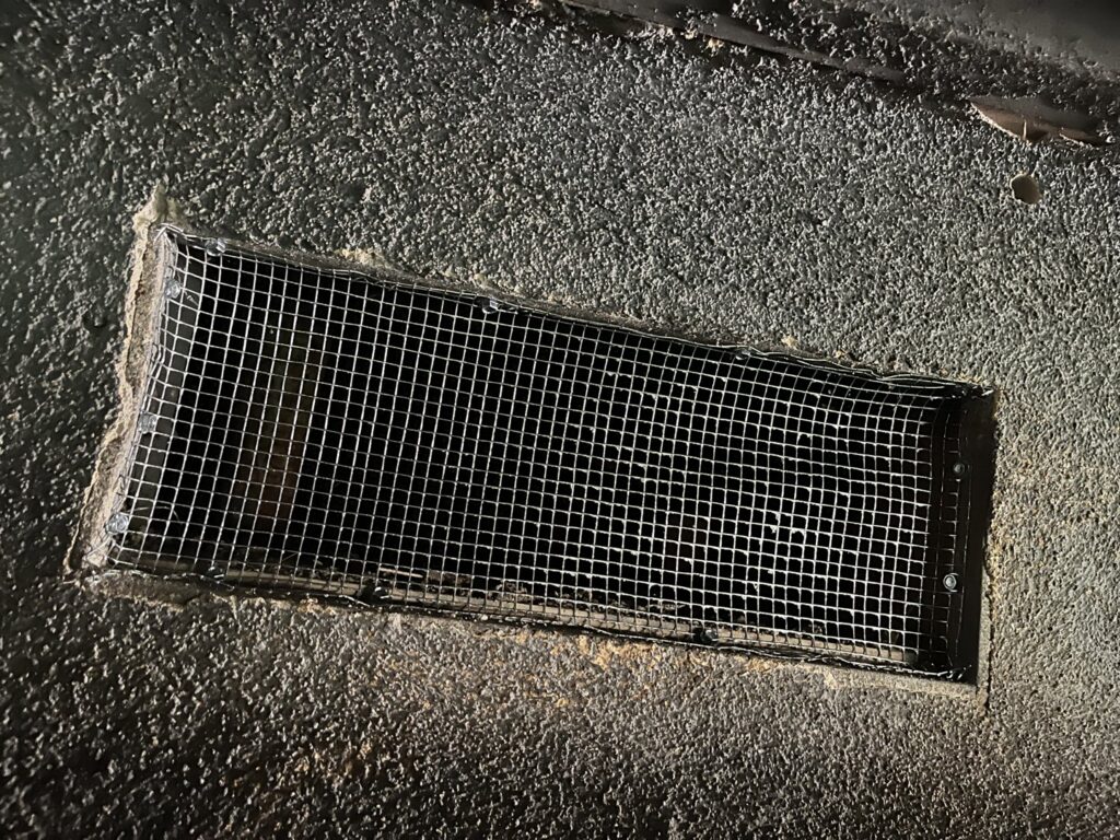 A foundation vent covered with wire mesh for pest exclusion by Ark Pest Management in Anaheim, CA.