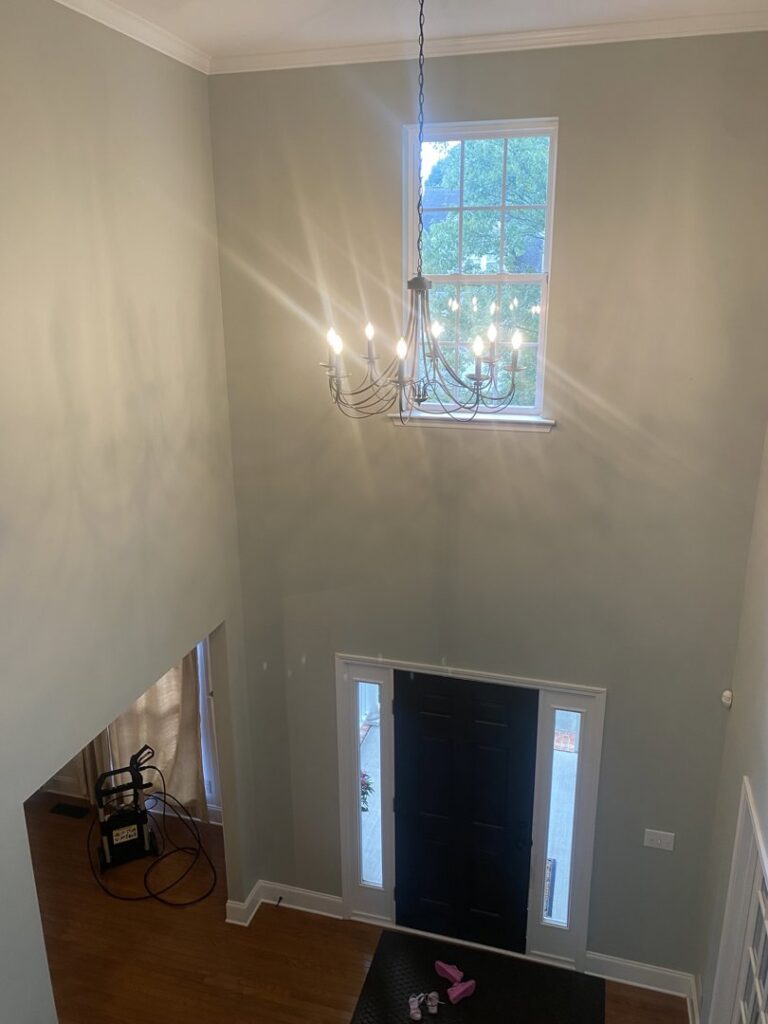 A chandelier installed in a high-ceiling foyer by Clarity Handyman Service in Raleigh, NC