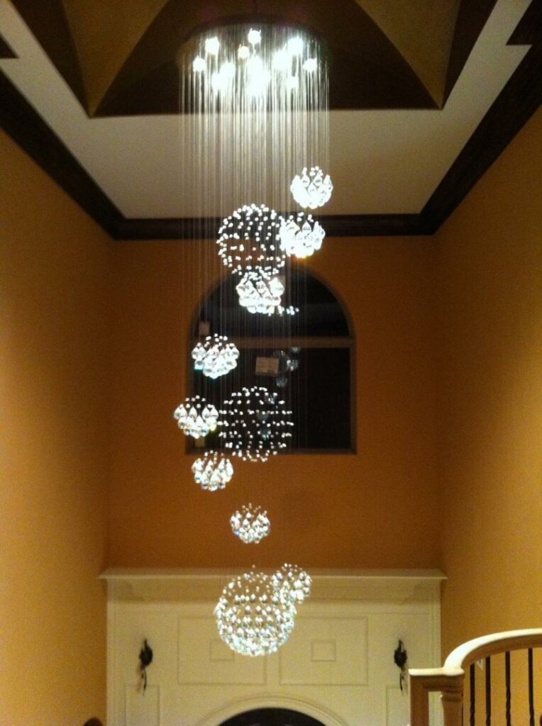 A multi-tiered chandelier installed in a tall foyer by Natural State Electric LLC in Fayetteville, AR.