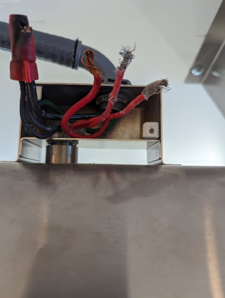 Close-up of frayed electrical wires inside a junction box, showing a repair need by Gold Electric INC in Bend, OR.