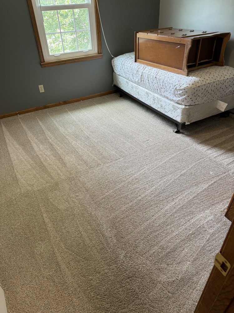A bedroom carpet freshly cleaned with visible cleaning lines, showcasing the professional service from BeClean in Charlotte, NC.