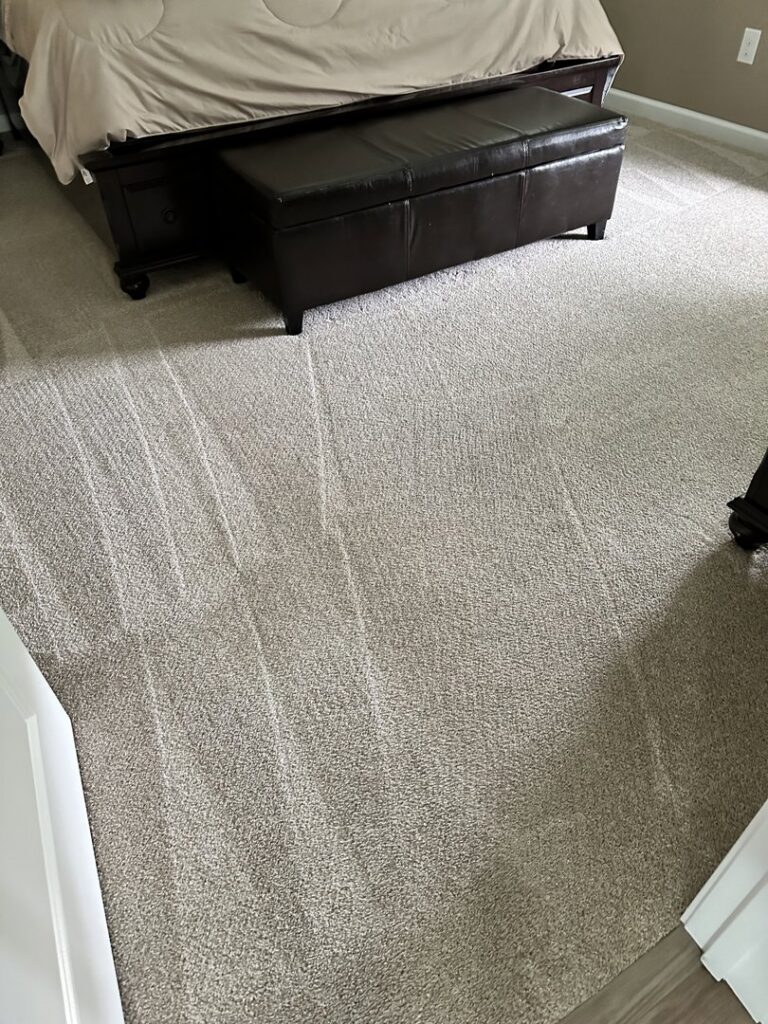 Freshly cleaned bedroom carpet with visible vacuum lines, showcasing the results from Carpet & Rug Cleaning in Mount Pleasant, SC.