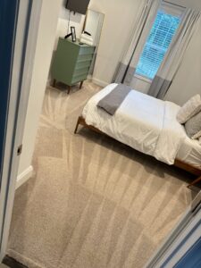A freshly cleaned, light-colored carpet in a bedroom with clear cleaning lines by LS Upstate Cleaning in Greenville, SC.
