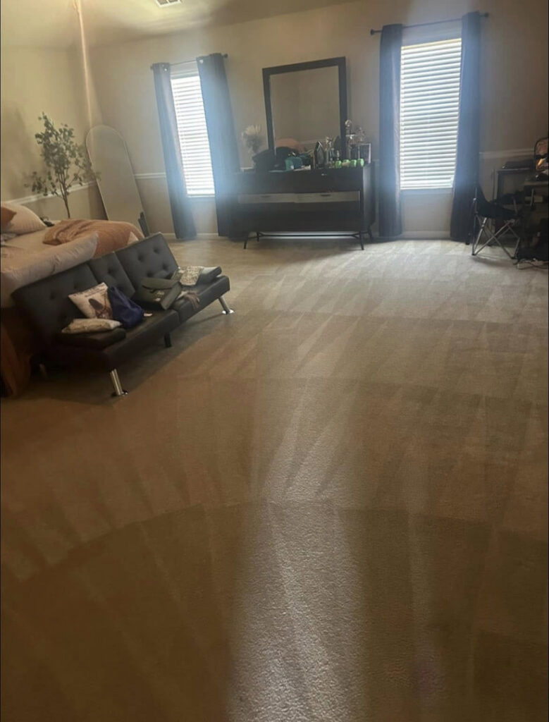 A large bedroom with a freshly cleaned carpet showing distinct cleaning lines, completed by Superior Carpet Cleaning in Greenville, SC.