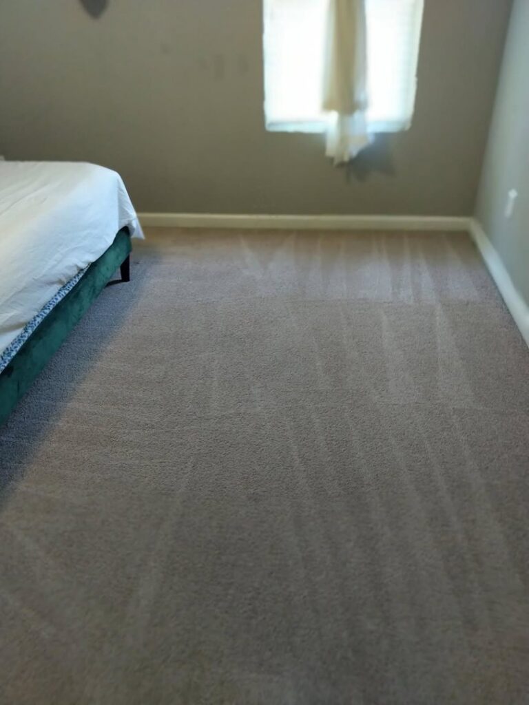 A freshly cleaned bedroom carpet with visible vacuum lines by Wilmington Carpet Cleaning NC in Wilmington, NC.