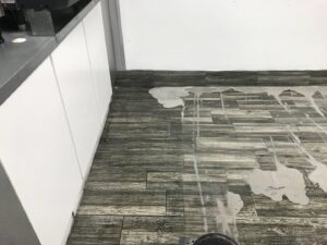 Freshly cleaned brown carpet in a bedroom with two beds, showing vacuum lines, by Technique Carpet & Tile Cleaning, Inc. in Winter Springs, FL.