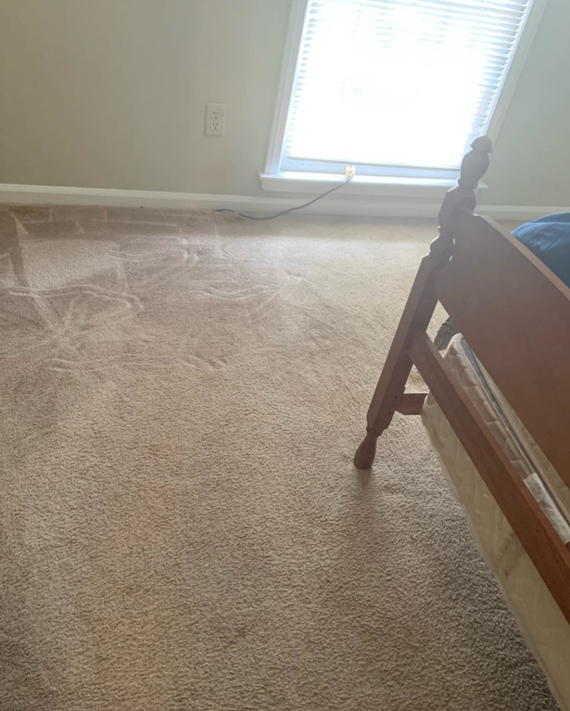 Freshly cleaned carpet with visible cleaning patterns in a bedroom by Holland's pressure washing and carpet cleaning LLC in Columbus, GA