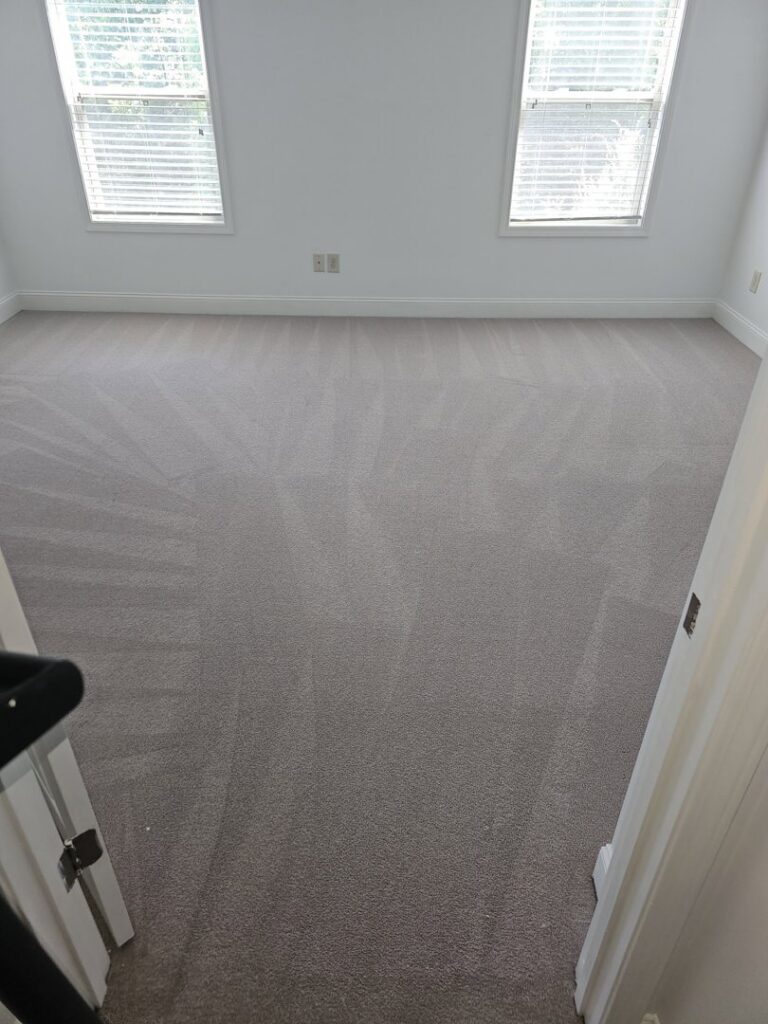 A freshly cleaned carpet with visible vacuum lines in an empty room by Right & Clean Atlanta 24-7 Carpet Cleaning in Atlanta, GA.
