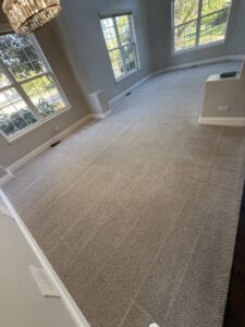 A freshly cleaned, light-colored carpet in a spacious living room, showcasing the quality work of Steam Choice Carpet Care Inc in Chicago, IL.