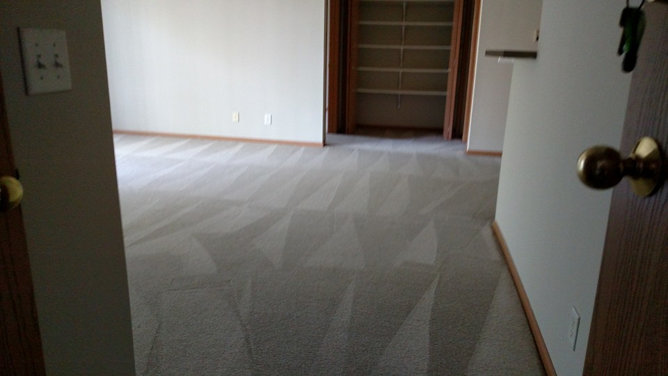 A freshly cleaned carpet with distinct vacuum lines in a residential room by CJ's Total Services LLC in Omaha, NE.