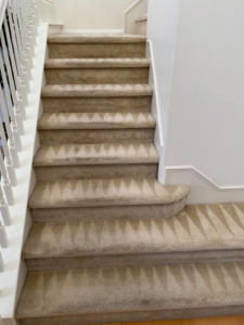 Freshly cleaned carpeted stairs with distinct cleaning patterns by Scott Carpet Cleaning OC in Anaheim, CA
