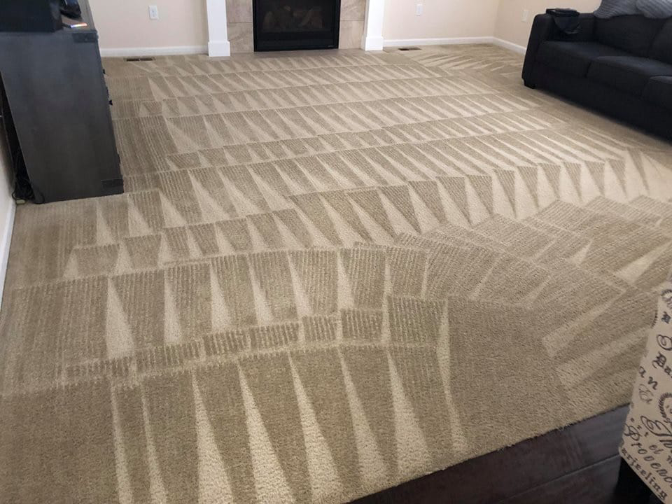 A freshly cleaned tan carpet with distinct cleaning patterns in a living room by Spot-On Carpet Care in Denver, CO.