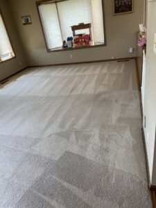 Freshly cleaned carpet with visible cleaning stripes in a residential room by Christenson Cleaning & Restoration in Hastings, NE.