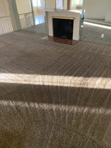 A room with freshly cleaned carpet showing distinct vacuum lines, a job completed by Dirt Busters, Inc. in Anaheim, CA.