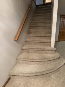 Freshly cleaned carpeted stairs after service by American Dream Carpet Cleaning in Cedar Rapids, IA.