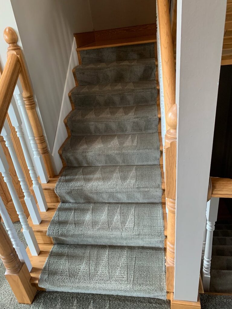 Freshly cleaned carpeted stairs showing distinct cleaning lines by Carpet Cleaning Pros LLC in Eau Claire, WI.