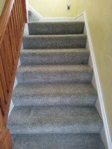 A freshly cleaned carpeted staircase, showing excellent results from Fiber Dry Carpet & Upholstery Cleaning in Dayton, OH.