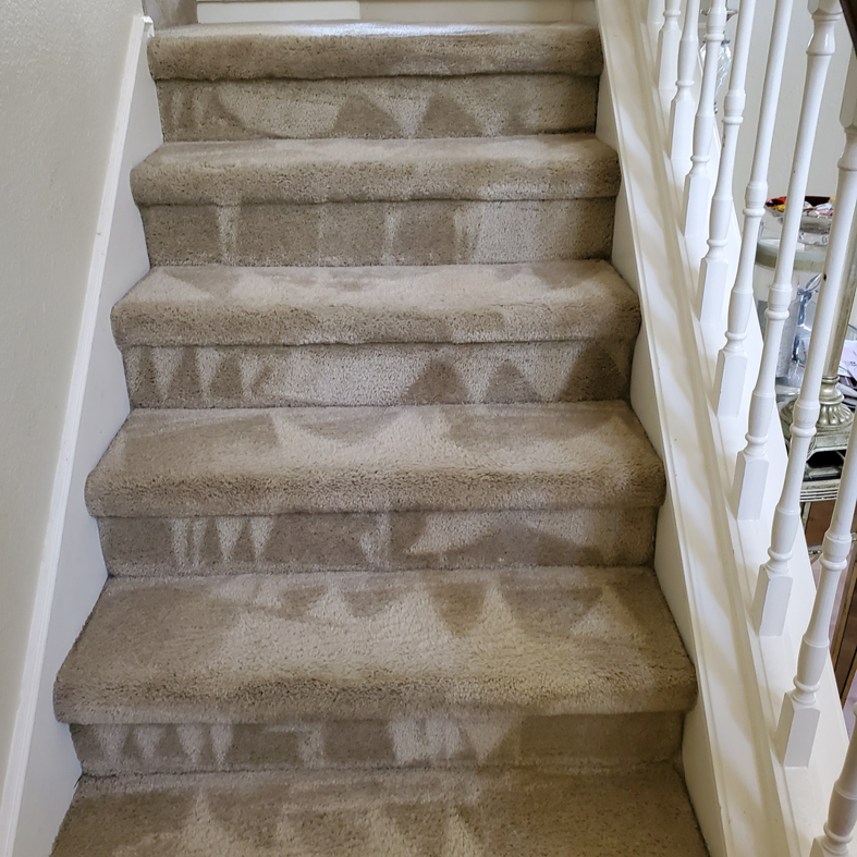 Freshly cleaned carpeted stairs showing distinct cleaning lines by Genie Clean Services LLC in Dallas, TX.