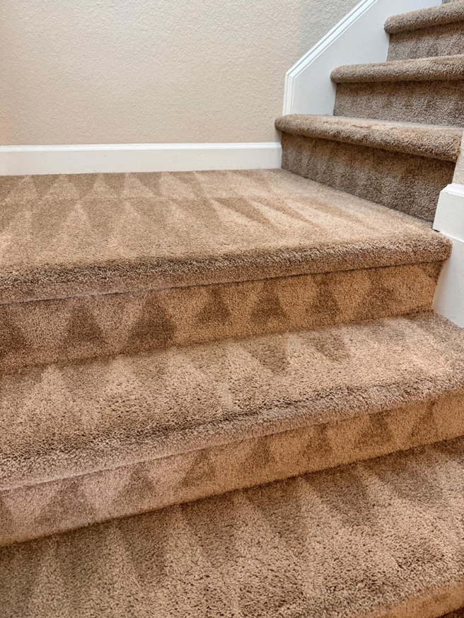 Freshly cleaned carpeted stairs showing distinct cleaning lines by Jam Carpet Cleaning Services LLC in Newport News, VA.