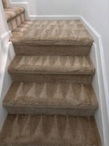 Freshly cleaned carpeted stairs with visible cleaning patterns by M&M Carpet & Tile Care in Cape Coral, FL