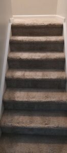 Freshly cleaned carpeted stairs, showing a professional finish by TCK Carpet Cleaning in Indianapolis, IN.