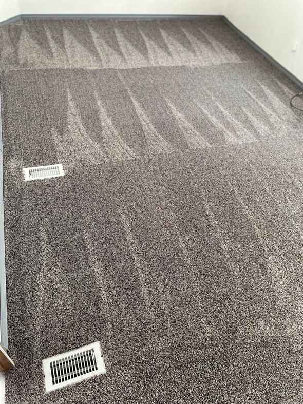 A freshly cleaned grey carpet with visible cleaning lines by Nick's Carpet Cleaning in Snohomish, WA.