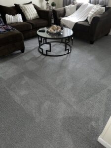 A freshly cleaned grey living room carpet with visible vacuum lines by Fiber Dry Carpet & Upholstery Cleaning in Dayton, OH.
