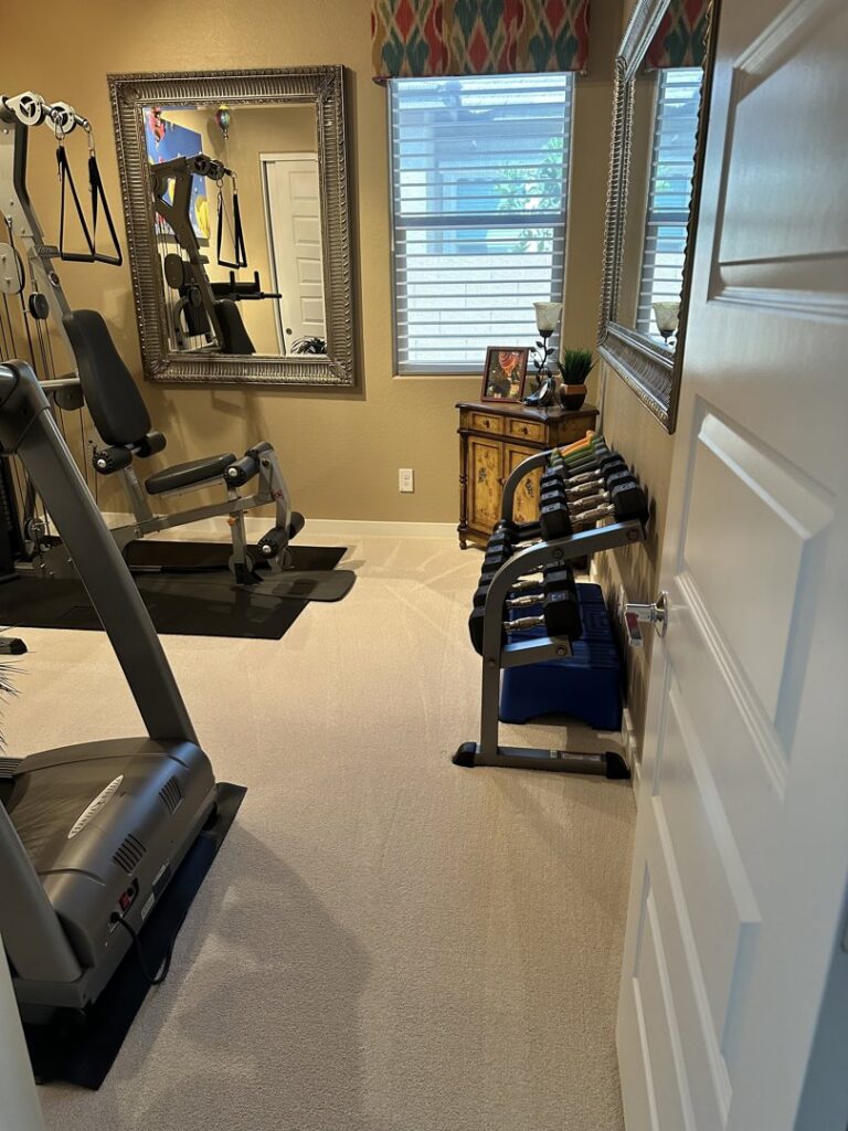 A freshly cleaned carpet in a home gym with visible cleaning lines by Healthy Living Carpet & Tile Cleaning in Peoria, AZ.