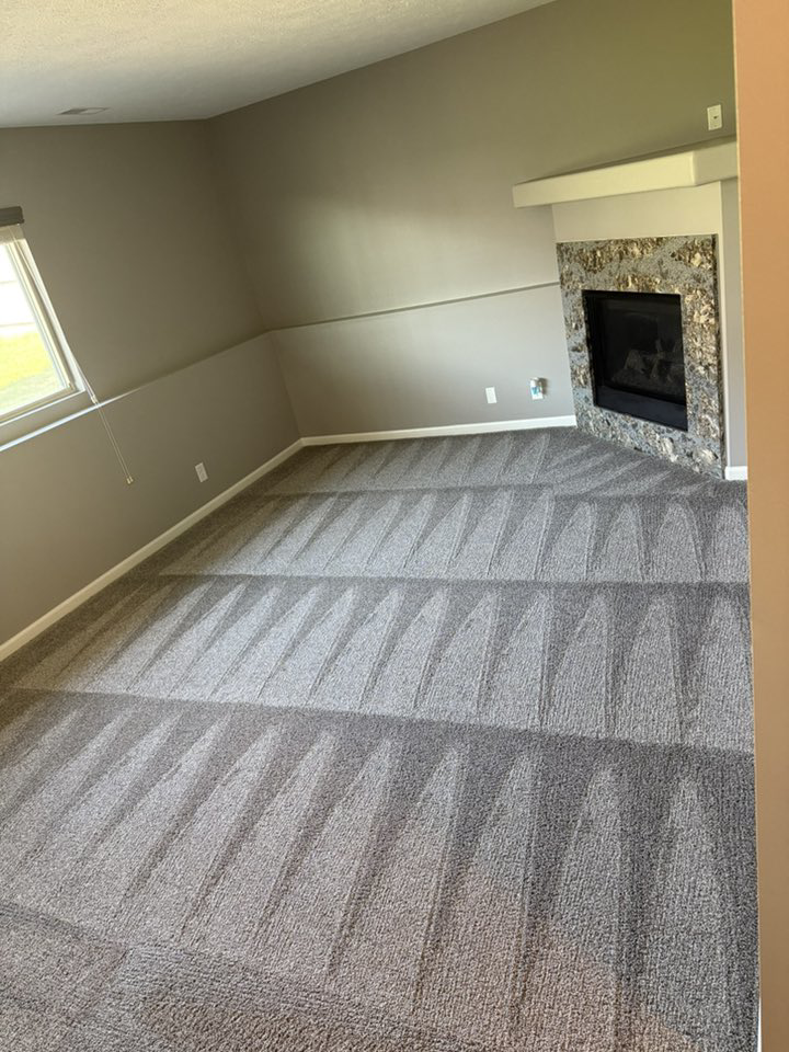 A freshly cleaned living room carpet with distinct vacuum lines by Midwest Carpet Rescue in Omaha, NE.