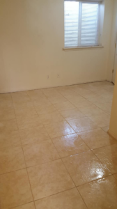 A freshly cleaned or newly installed tile floor in an empty room by Clean Time in Lombard, IL.