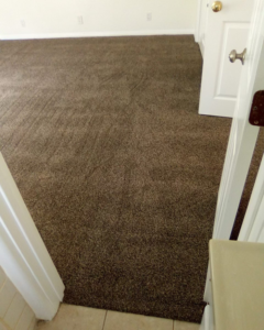 Freshly installed brown carpet in a bedroom by Jimenez Carpet in Lynwood, CA