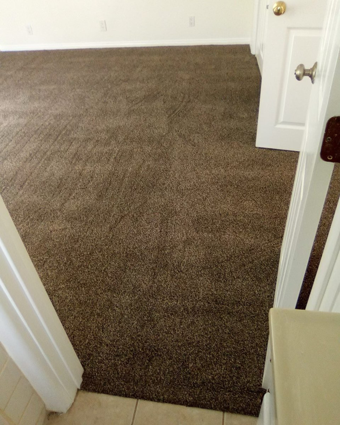 Freshly installed brown carpet in a bedroom by Jimenez Carpet in Lynwood, CA